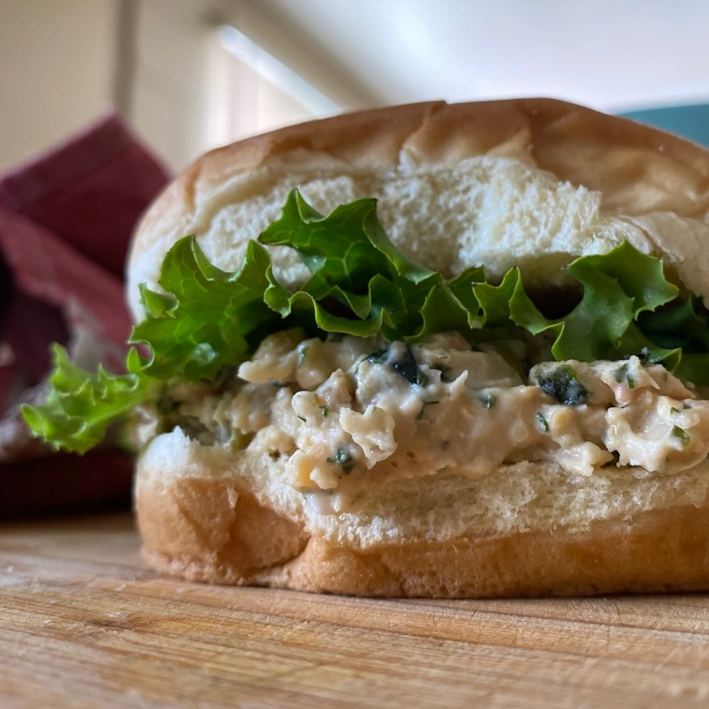 Vegan tuna sandwich on a hamburger bun with lettuce